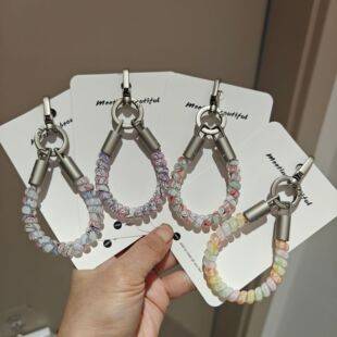 Trendy phone charm with colorful graffiti design, phone cord, anti-loss and anti-drop phone strap, keychain, and fashionable bag accessory
