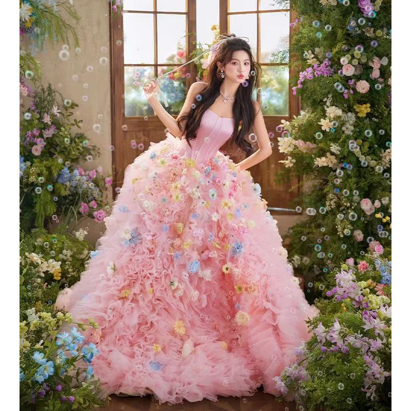 New pink wedding dress theme for couples' indoor photography at the photo studio, featuring a high-end, sweet style with floral strapless design and colorful tulle