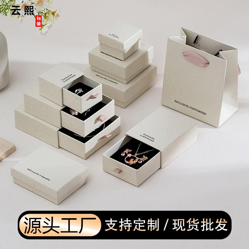 Manufacturer's in-stock recycled paper jewelry boxes with clear texture for rings, necklaces, and bracelets